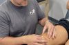 physical therapist working with athlete patient during orthopedic evaluation