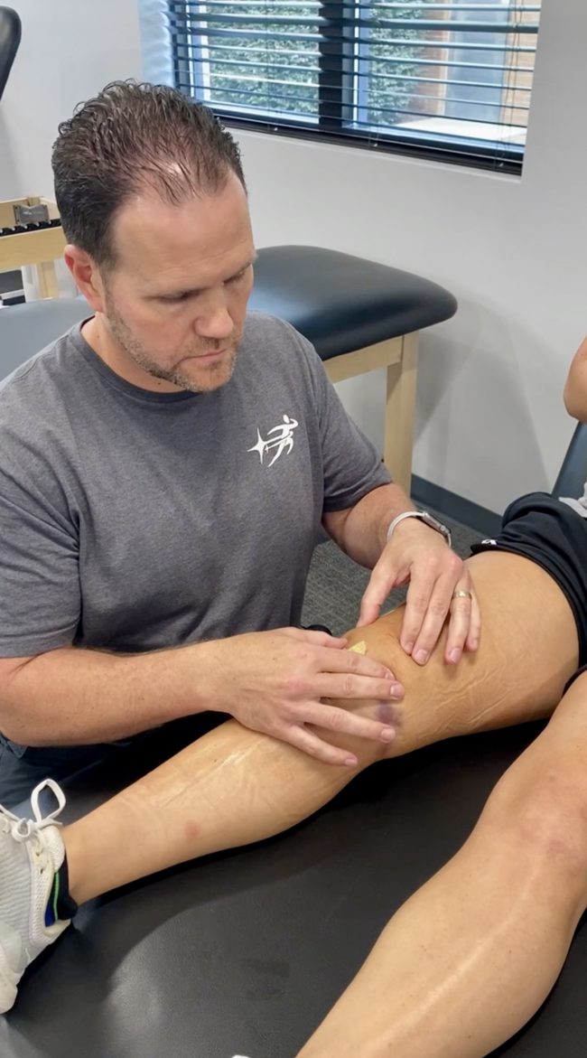 physical therapist working with athlete patient during orthopedic evaluation
