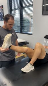 Patient working with a provider at a physical therapy clinic in Raleigh, NC during a functional movement assessment