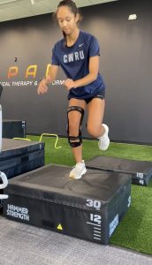 physical therapist performing movement assessment with a patient